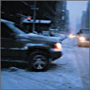 Photo of SUV at snowy intersection
